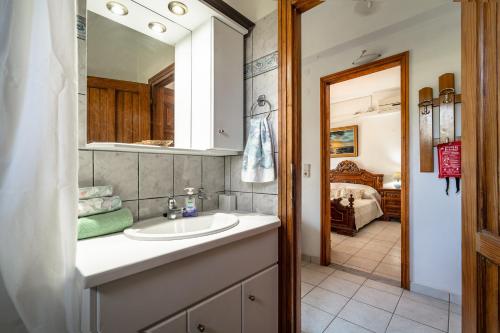 a bathroom with a sink and a mirror at Makis Apartment Katelios in Khionáta