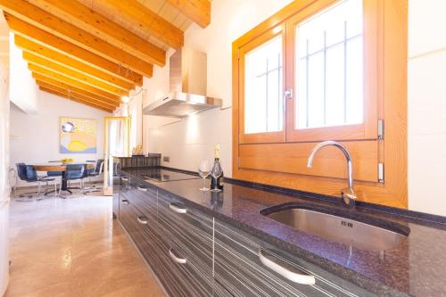 a kitchen with a sink and a window at Finca Son Fornes in Búger