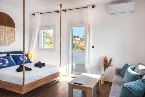 a room with a swing bed and a couch at Mont' Rock villas 1 in Posidhonía