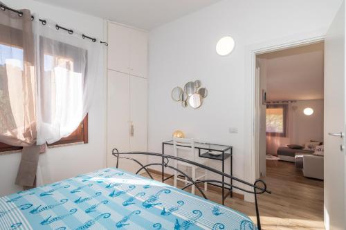 a bedroom with a bed and a living room at Villa Aloe 2 in Costa Paradiso
