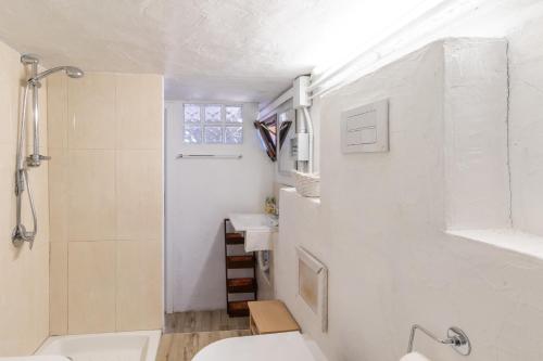 a white bathroom with a sink and a toilet at Villa Aloe 2 in Costa Paradiso