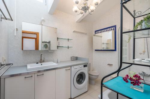 a bathroom with a washing machine and a sink at Villa Villena Torrox in Torrox