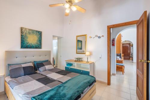 a bedroom with a bed and a ceiling fan at Villa Villena Torrox in Torrox