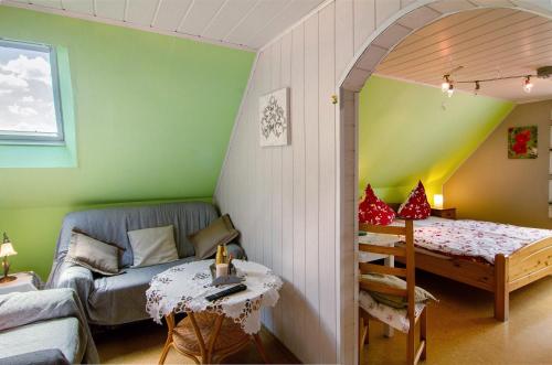 a living room with a couch and a table at Ferienhaus Gerda Wohnung 2 in Westochtersum