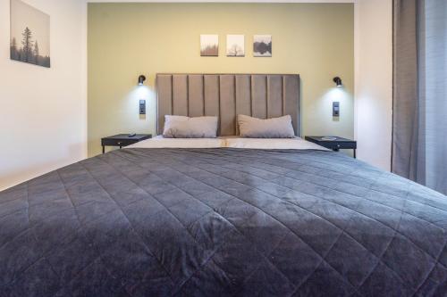 a bedroom with a large bed with two night stands at Egge Resort 7d mit Whirpool u Sauna in Altenbeken