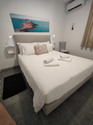 a large white bed with two towels on it at Funchal House in Funchal