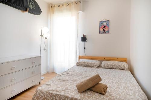 a bedroom with a bed and a dresser at Appartement Notre Dame in Capbreton
