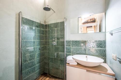 a bathroom with a sink and a shower at Radicondoli Studio in Radicondoli