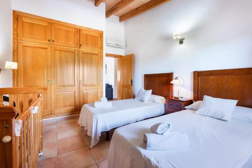 a bedroom with two beds with towels on them at Can Mirló in Marratxí 