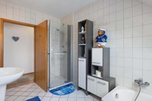 a bathroom with a shower and a figurine on a shelf at Ferienwohnung Storchennest in Burg