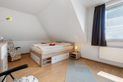 a small bedroom with a bed and a window at Ferienwohnung Storchennest in Burg