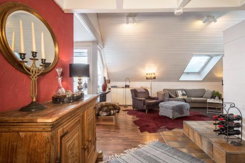 a living room with a large mirror on the wall at Dachatelier Überlingen in Überlingen
