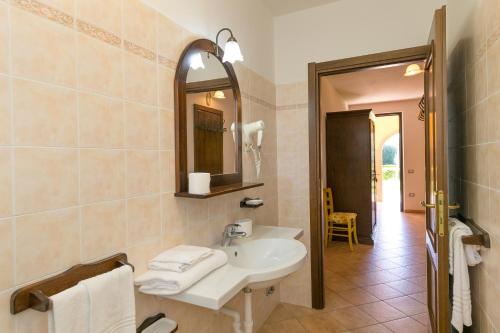 a bathroom with a sink and a mirror at Il Girasole - Limone in Venturina Terme