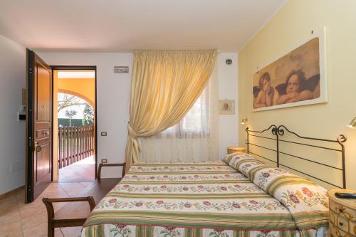 a bedroom with a bed and a window at Il Girasole - Limone in Venturina Terme