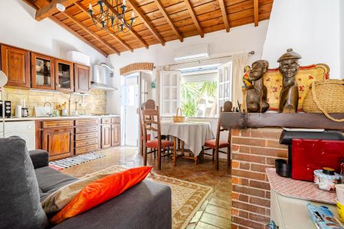 a kitchen and living room with a couch and a table at Casa Da Guia in Beja