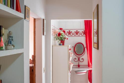 a room with a red curtain and a table with a mirror at Oasi del borgo Montefollonico in Montefollonico