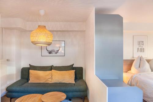 a living room with a couch and a bed at Höllental 51 in Garmisch-Partenkirchen