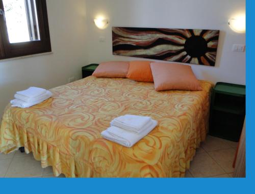 a bedroom with a bed with towels on it at Isola Di Favignana in Favignana
