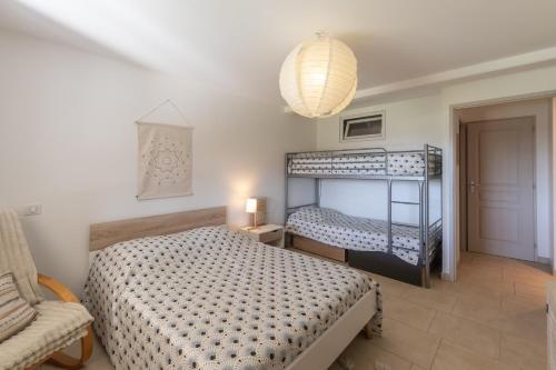 a bedroom with two bunk beds and a lamp at Logement spacieux agréable in Saint-Privat