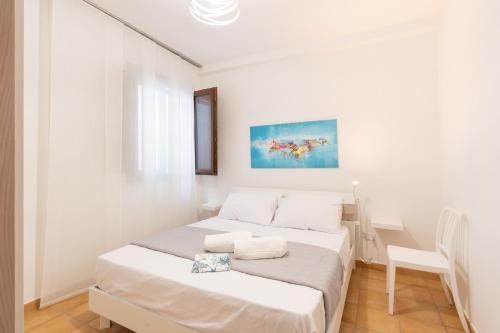 a white room with two beds in it at Summer Spritz in Custonaci