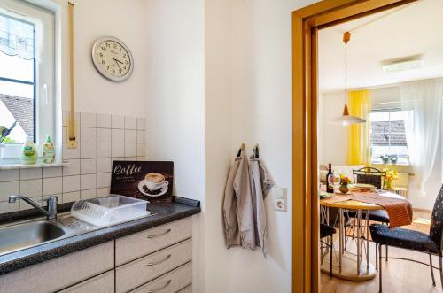 a small kitchen with a sink and a table at Relaxen am Illmensee in Illmensee