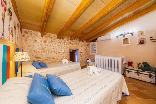 a bedroom with two beds with stuffed animals on them at Finca Fonoll in Santa Margalida