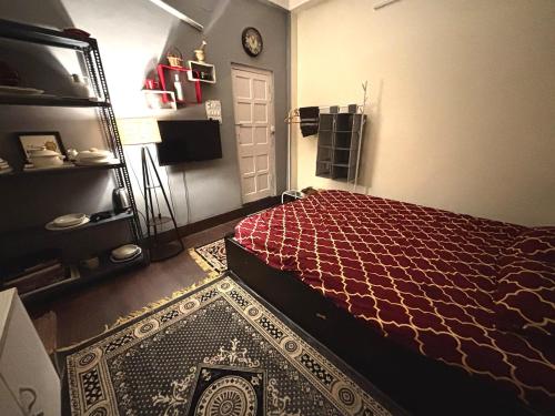 a bedroom with a bed and a door with a rug at Large room with terrace in Kolkata