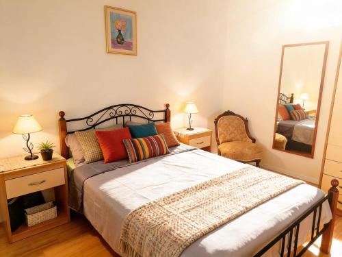 a bedroom with a large bed and a mirror at Dream Home in Lopud