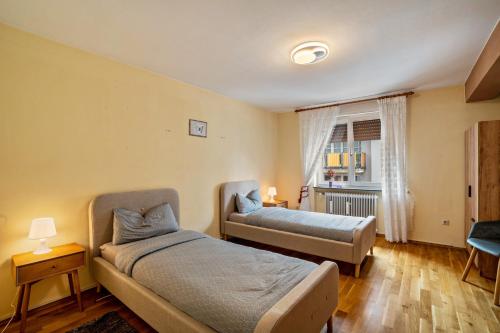 a bedroom with two beds and a window at Apartment Albert-Schulte Park in Worms