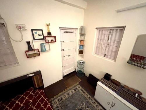 a room with a white door and a window at Large room with terrace in Kolkata