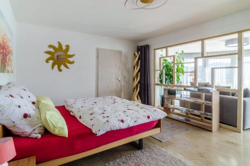 a bedroom with a bed with a red blanket at Ferienparadies Bodensee Fewo2 in Billafingen
