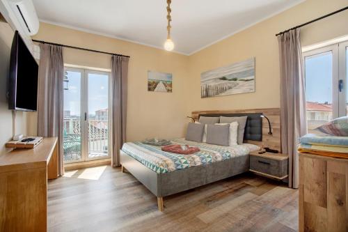 a bedroom with a bed and a large window at Home Away From Home in Peniche