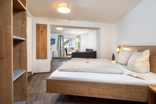 a bedroom with a large bed with white sheets and pillows at Haus Sabrina Masnerjoch in See