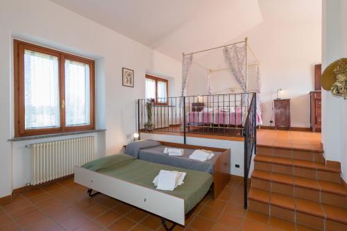 a room with a bed and a crib in it at Tenuta Vallegaia in Rosignano Marittimo
