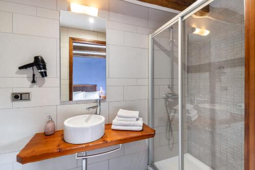 a bathroom with a sink and a shower at Casamira in Sagás