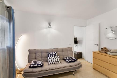 a living room with a couch with pillows on it at Casa Paula - 24 in Arinaga