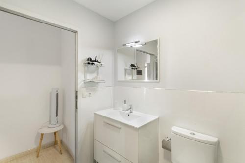 a white bathroom with a sink and a toilet at Casa Paula - 24 in Arinaga