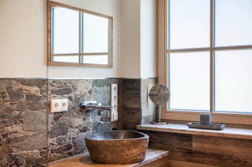 a bathroom with a large bowl sink and windows at Ferienwohnung Johanni in Farchant