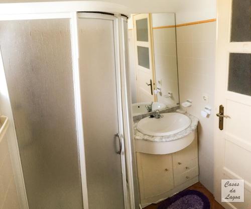 a bathroom with a sink and a mirror at Casas Da Lagoa - T2 Norte in Aldeia de Brescos