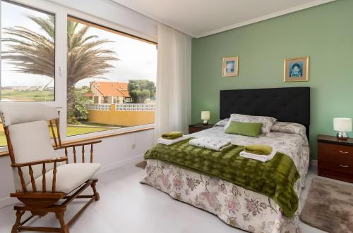 a bedroom with a bed and a large window at Villa Laurana in Suances