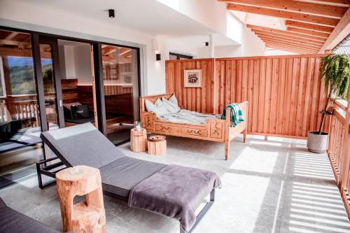 a bedroom with a bed and a chair at Kieserhof Apartment Alm in Terento