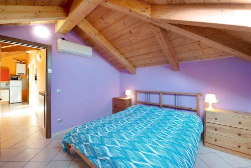 a bedroom with a bed and a wooden ceiling at Trilocale in villa Apt 5 in Varazze