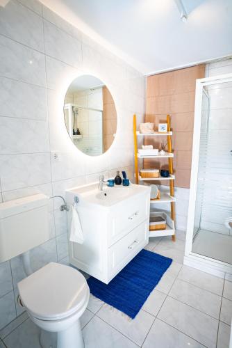 a bathroom with a sink and a toilet and a mirror at Royal Delft Boutique Apartment in Dinslaken