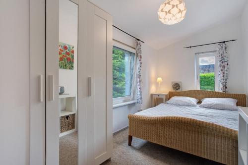 a bedroom with a bed and a window at Landhaus Peenemünde - Garten in Peenemünde