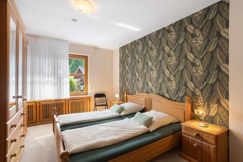 a bedroom with a bed in a room with a window at Ferienwohnung Christa in Lennestadt