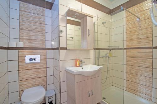 a bathroom with a sink and a toilet and a shower at Andromaches sea view studio in Corfu