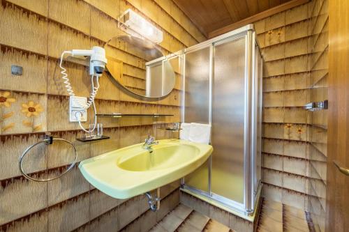 a bathroom with a sink and a shower at Residence Kronstein - Fewo 7 in Tesimo