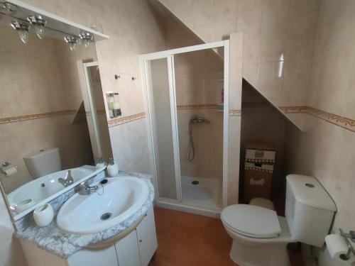 a bathroom with a sink and a toilet and a shower at Casa da Avó Cândida in Granja
