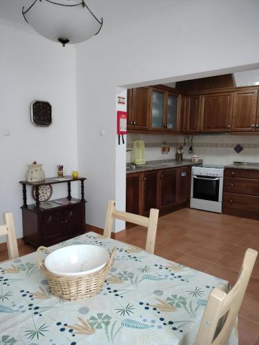a kitchen with a table with a bowl on it at Casa da Avó Cândida in Granja