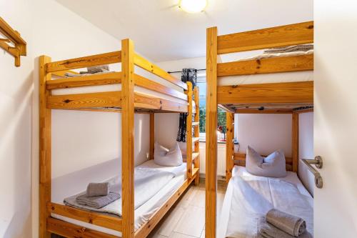 two bunk beds in a room with a hallway at Fewo Zur Piste in Willingen
